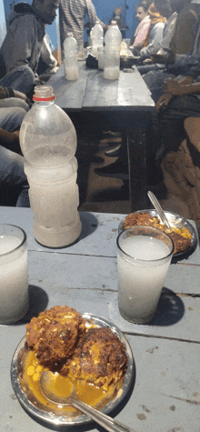 a bottle of milk sits on a table next to some food