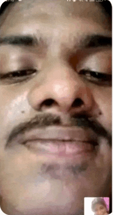 a man with a mustache is talking to another man on a video call