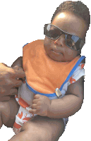 a baby wearing a bib and sunglasses is being held by someone