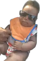 a baby wearing a bib and sunglasses is being held by someone