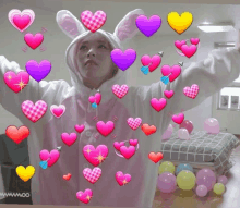 a woman in a bunny costume is surrounded by pink hearts