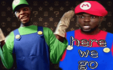 two men dressed up as mario and luigi with the words here we go