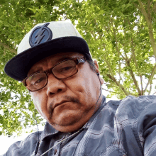 a man wearing a hat with a lightning bolt on it looks at the camera