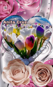 a heart shaped display of flowers with the name anita cruz above it