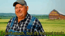 a man standing in a field with a sign that says cum farms in the background