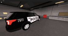 a black and white emergency 911 police car in a garage