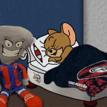 a stuffed animal is sitting next to a stuffed animal with a blanket that says cerro porteno