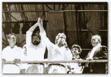 a black and white photo of a man holding up his hand