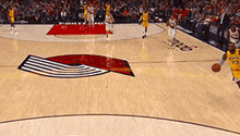 a basketball game is being played on a court with a logo on the floor