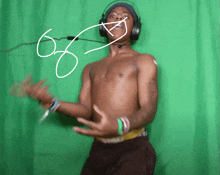 a shirtless man wearing headphones and a microphone with the number 66 written on his face