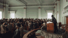 a man stands at a podium in front of a large crowd in front of a sign reading morning hour