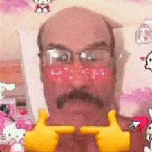 a man with glasses and a mustache is laying on a bed with hello kitty on it .