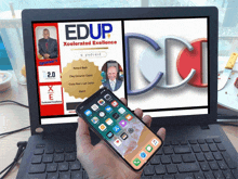 a person is holding a cell phone in front of a laptop with edup xcelerated excellence on the screen