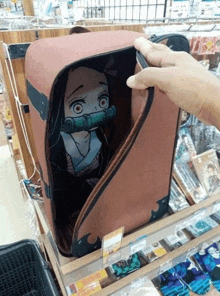 a person is holding a red suitcase with a picture of a girl on it