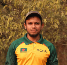 a man wearing a green and yellow shirt with bcsa on it