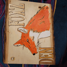 a drawing of a fox on a piece of wood that says fox on it