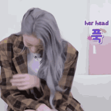 a woman in a plaid jacket has a sticker that says " her head "