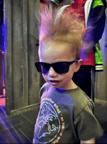 a young boy wearing sunglasses and a shirt that says the matter what on it