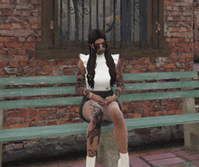 a woman sits on a green bench with a brick wall in the background