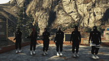 a group of people standing in front of a rocky mountain