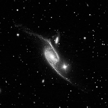 a black and white image of a galaxy in the night sky