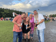 a man with a beard holds a can of bud light in his hand