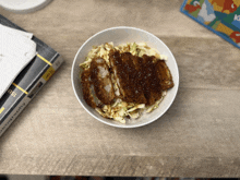 a bowl of food is on a table next to a book called economics