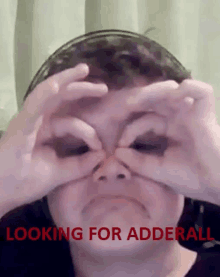 a person is looking through a pair of binoculars with the words " looking for adderall " below them