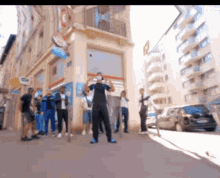 a group of people are standing on a sidewalk in front of a building with a burger king sign on it