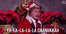 a man dressed as santa claus is singing the song fa-la-la-la-la chanukah .