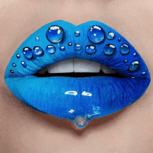 a close up of a woman 's lips with blue lipstick and water drops on them