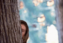 a person peeking out from behind a tree with the words grandoldmemes written on the bottom