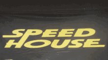 a black banner with yellow letters that reads speed house