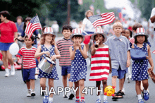 a group of children march down a street with the words happy 4th