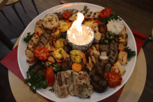 a plate of food with a candle in the middle