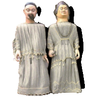 two statues of a man and a woman standing next to each other