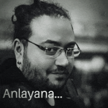 a black and white photo of a man with glasses and the words anlayana