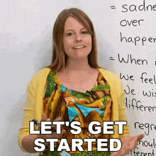 a woman is standing in front of a white board with the words let 's get started written on it