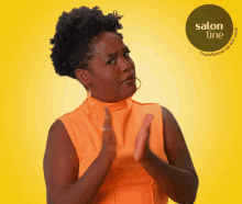 a woman clapping in front of a yellow background with a salon line logo