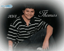 a young boy wearing a black and green striped shirt is posing for a picture with the name thomas .