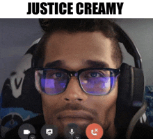 a man wearing glasses and headphones is talking on a video call with the caption " justice creamy "