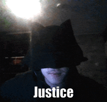 a man in a batman costume has the word justice written on the bottom