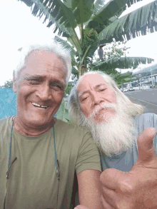 two men are posing for a picture and one has a beard