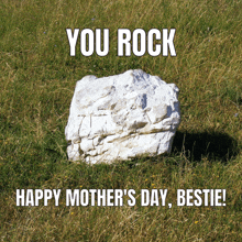 a white rock in the grass with the words you rock happy mother 's day bestie on it