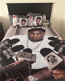 a bed with a duvet cover with a picture of a young boy on it