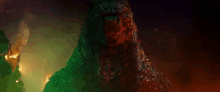 a close up of a monster 's face with a green light behind it