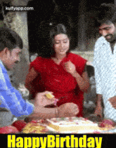 a woman in a red dress is standing in front of a cake with the words happy birthday on the bottom