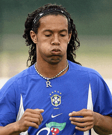 a man wearing a blue shirt that says ' brasil ' on it