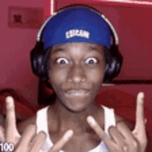 a young man wearing headphones and a blue headband that says cougar on it