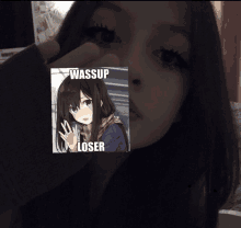 a girl is holding a picture of a girl with the words wassup loser on it